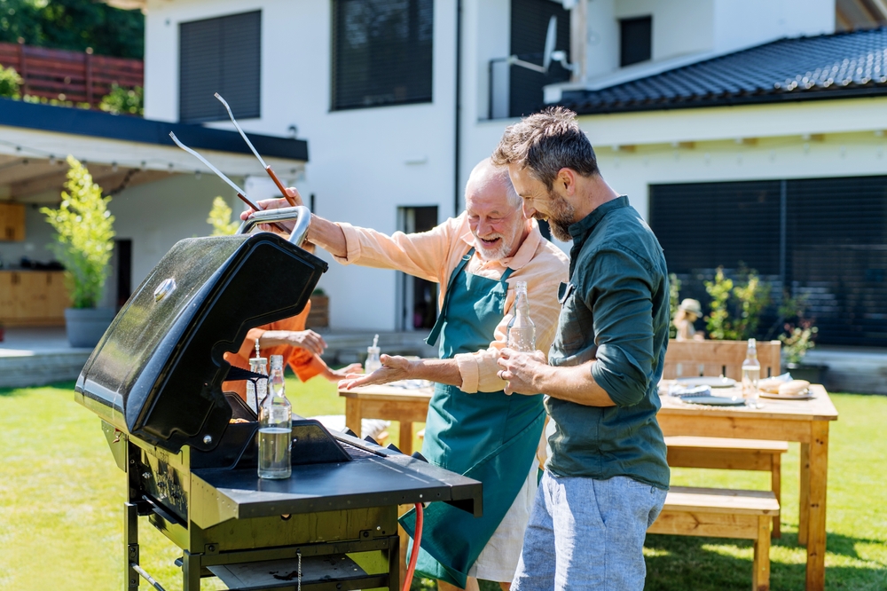 father and son grilling in the backyard